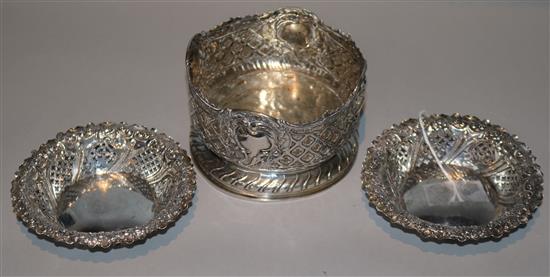 A pair of late Victorian pierced silver bonbon dishes and a Continental pierced silver bottle coaster, 8.5 oz.
